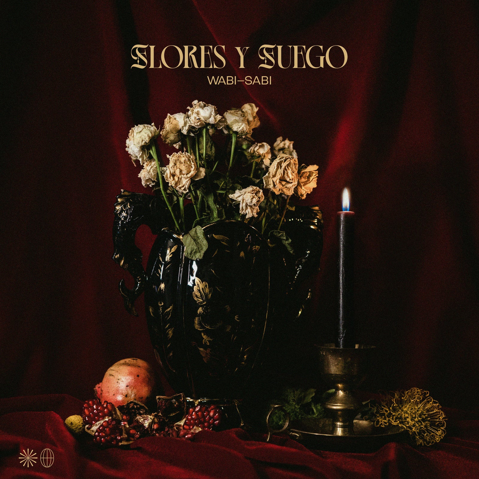 A moody still life of wilted flowers in a dark ornate vase, fruit, candle, and marigold on red cloth with deep red drapery. Above, the Flores Y Fuego brand name nods to “Wabi-Sabi” and hardcore punk from Pirates Press Records.