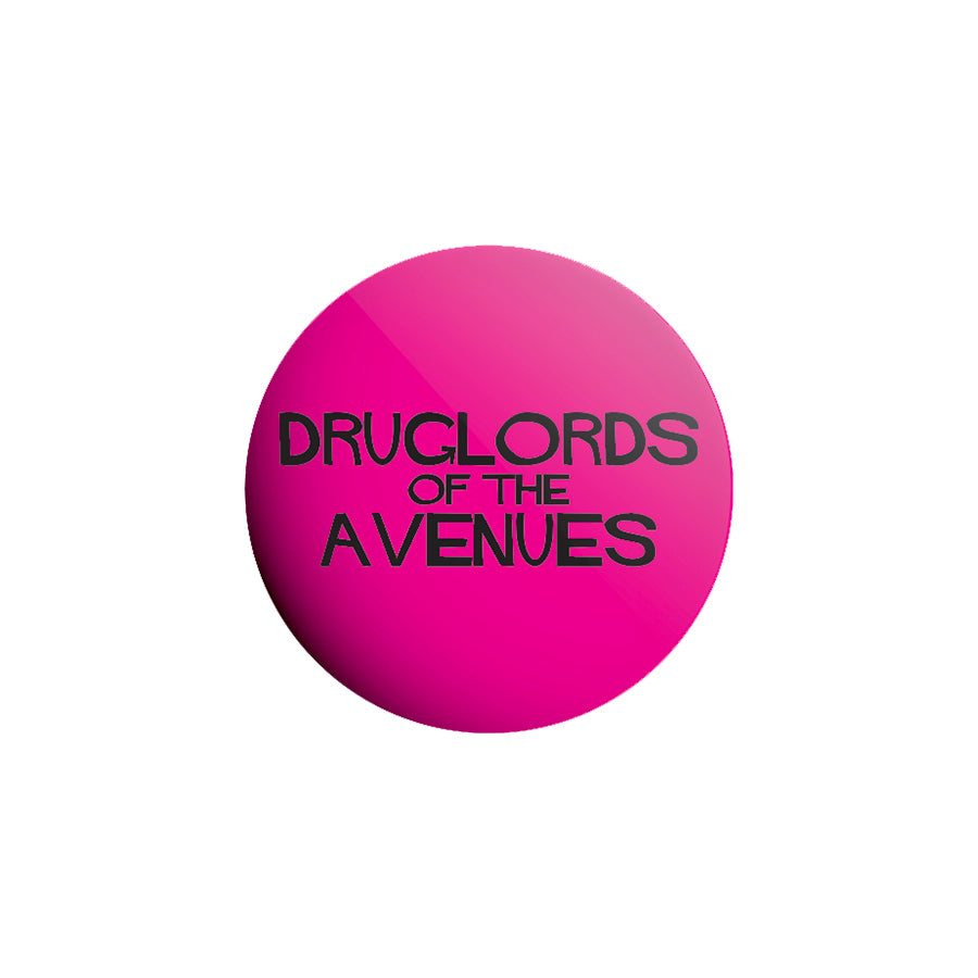 A round, bright pink collectible button with black text that says "Druglords of The Avenues" centered on it. Features a white background and is perfect for any button pack.