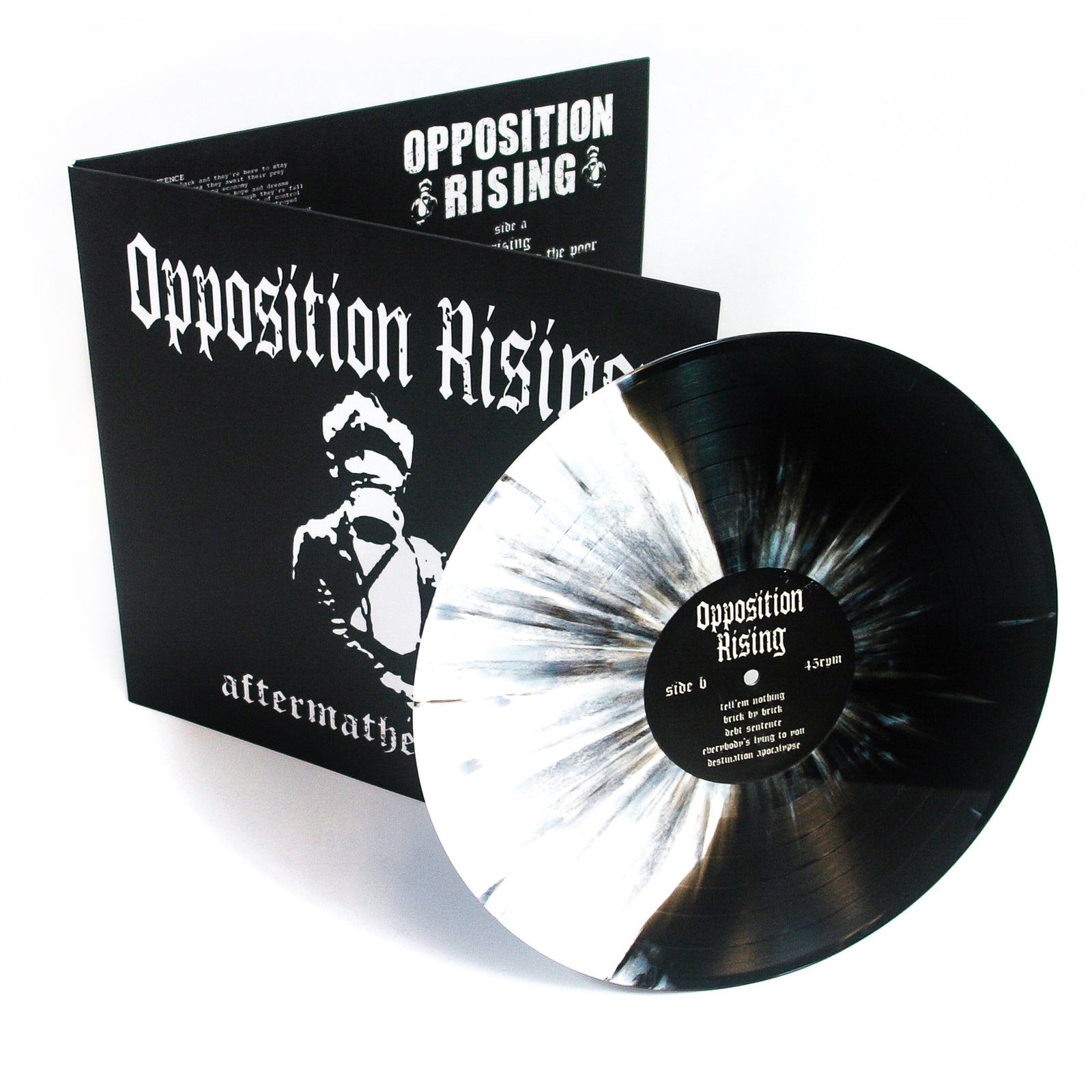 A black-and-white splattered vinyl by Opposition Rising is displayed before its matching album cover, which features bold white text and a masked figure illustration.