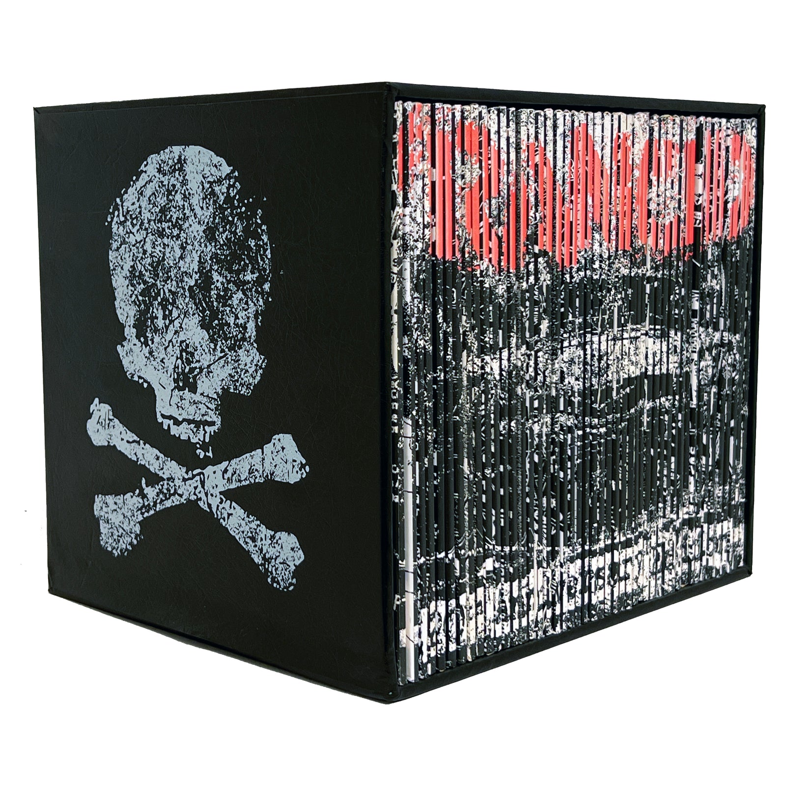 A black cube features a distressed white skull and crossbones on one side and vertical white and red lines with faded text on the other, celebrating the Rancid box set’s 20th anniversary with remastered vinyl.
