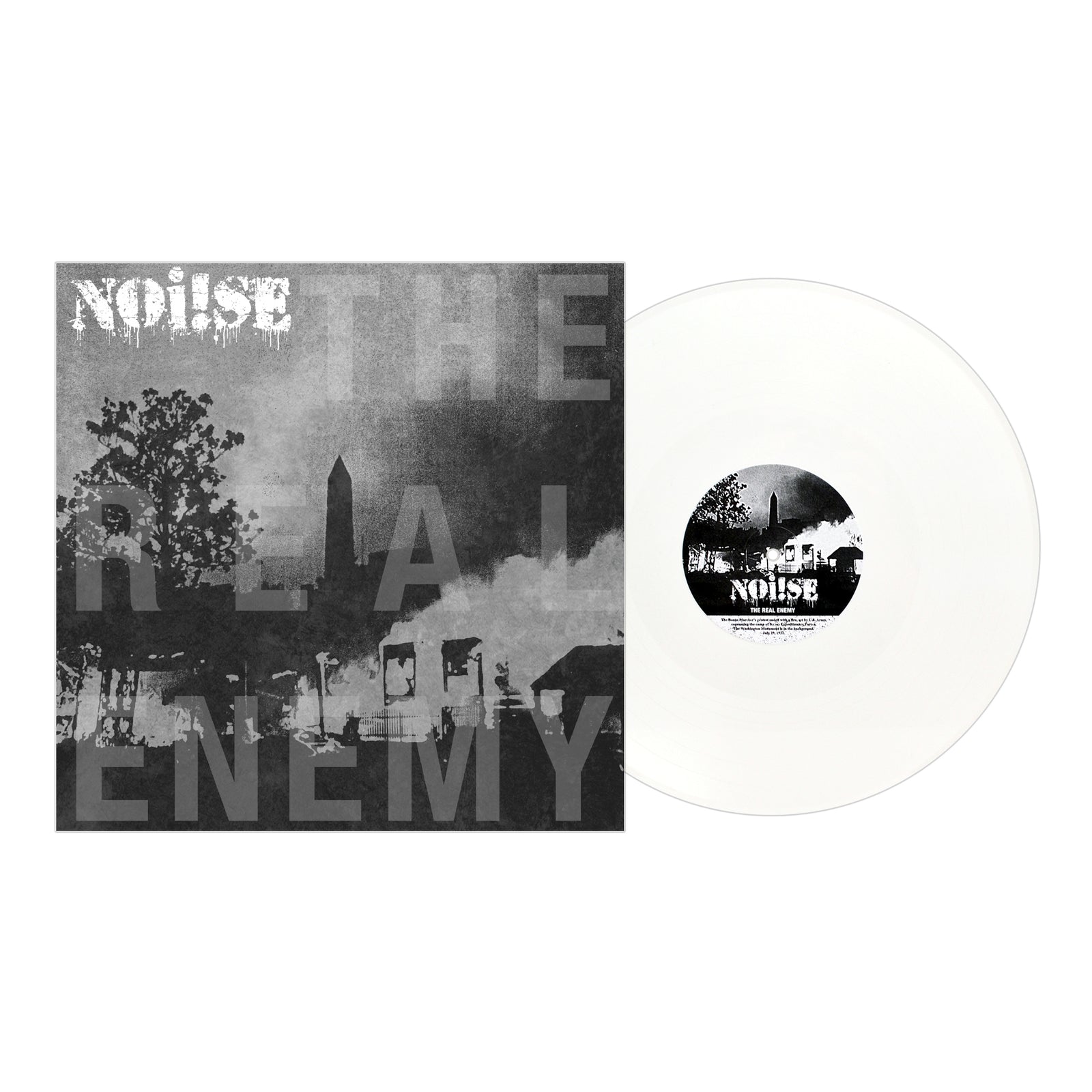 A white vinyl record by NOi!SE from Pirates Press Records sits next to its black-and-white cover, displaying NOi!SE and THE REAL ENEMY above a gritty urban scene with silhouettes of buildings and trees.