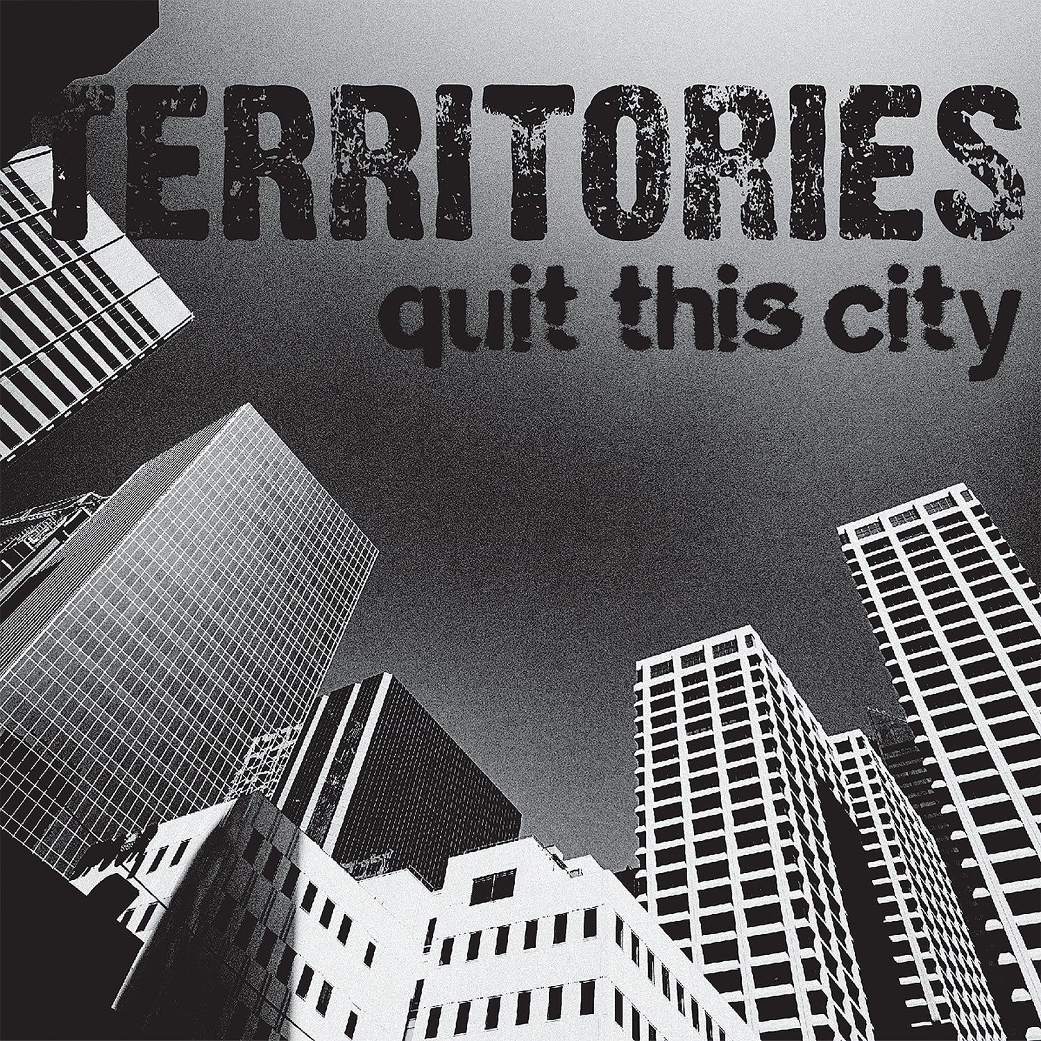 Black and white image of tall skyscrapers viewed from below with TERRITORIES quit this city in bold, distressed letters—a striking nod to Territories’ 7 Milky Clear Vinyl release, When The Day Is Done.