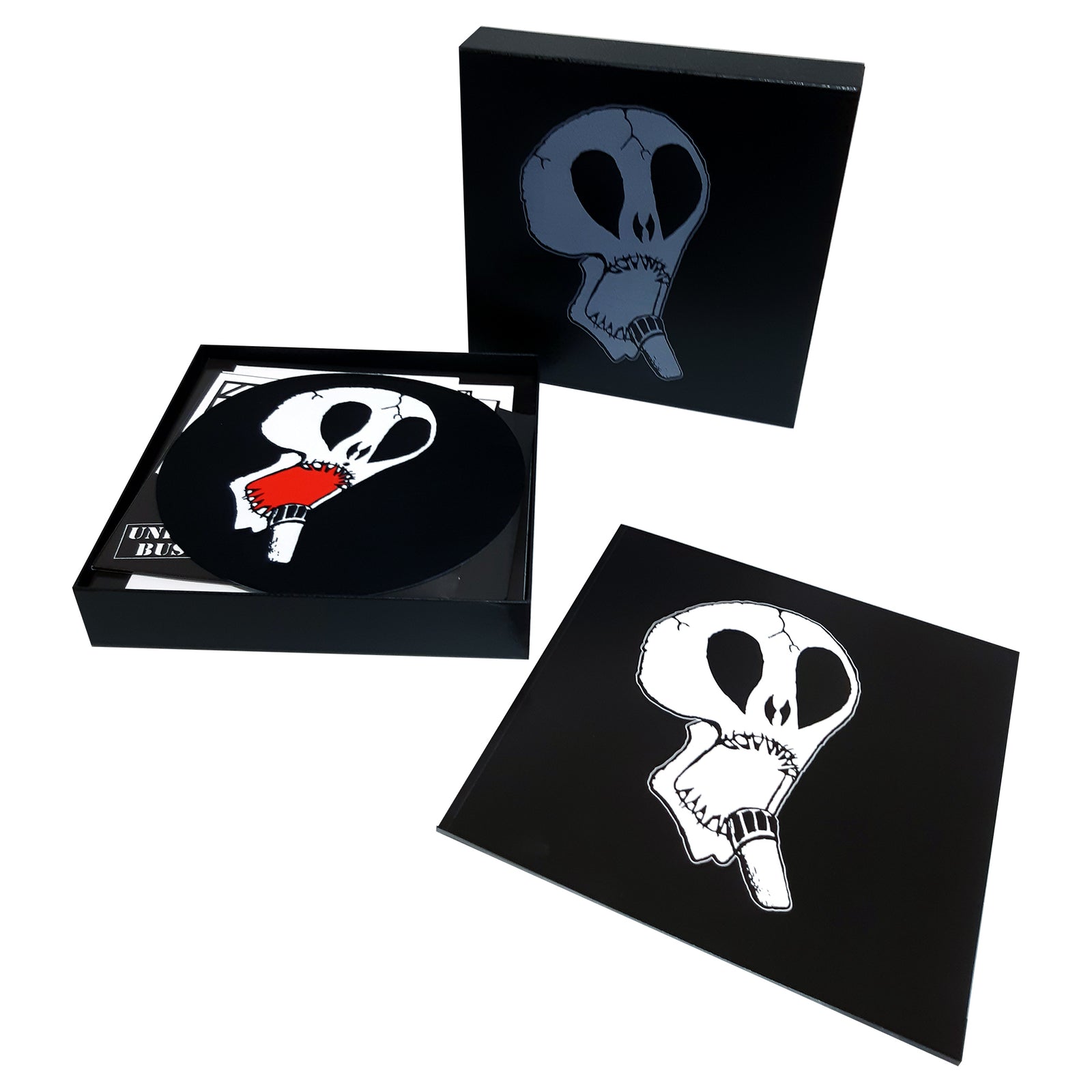 The Subhumans box set features a black cover with a white skull holding a pencil in its mouth. This anarcho punk collection includes a vinyl record, sleeve, and packaging—all branded with the iconic Subhumans skull design.