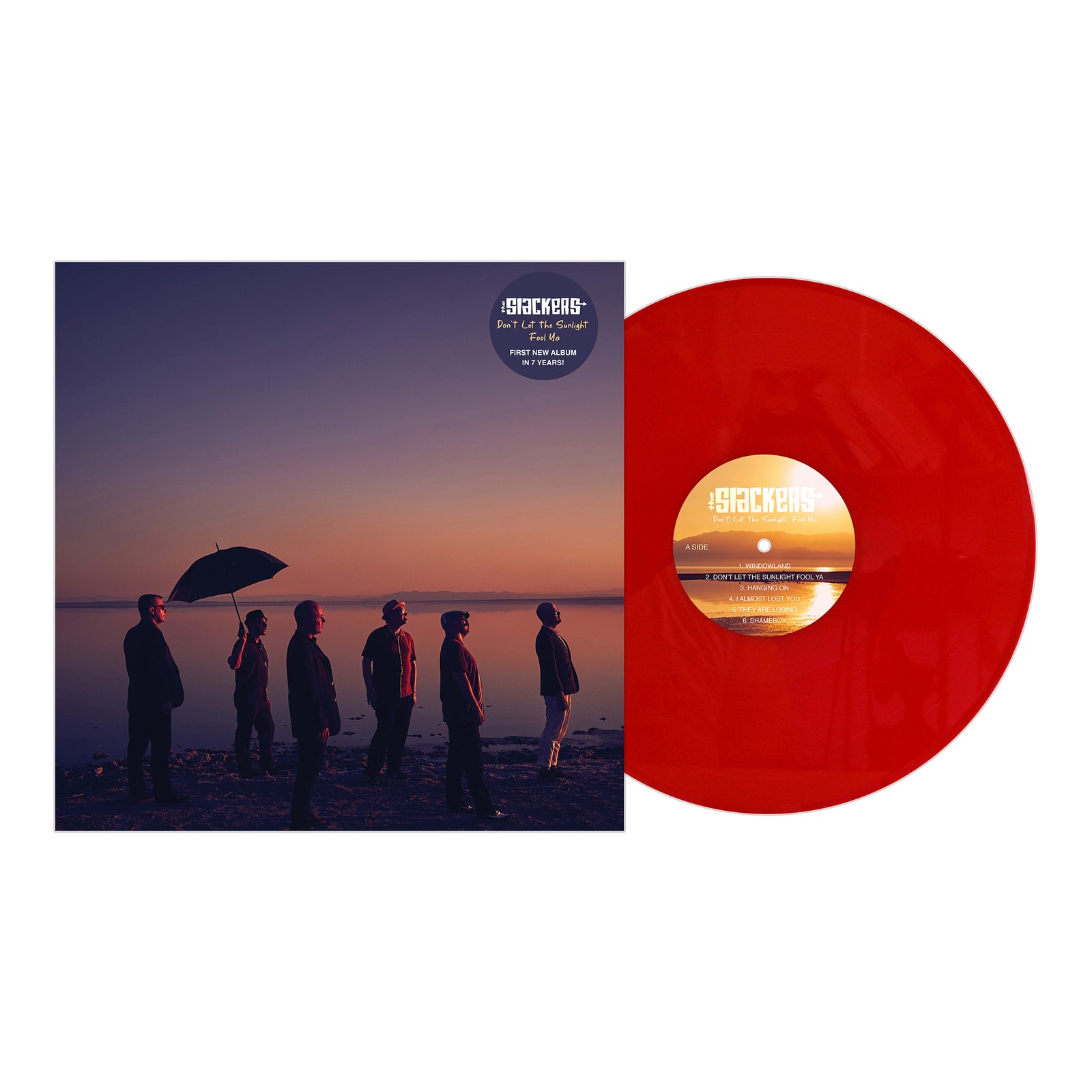 A red vinyl record by The Slackers is shown beside its album cover, which features six silhouetted figures by the water at sunset—one holding an umbrella—with The Slackers displayed at the top.