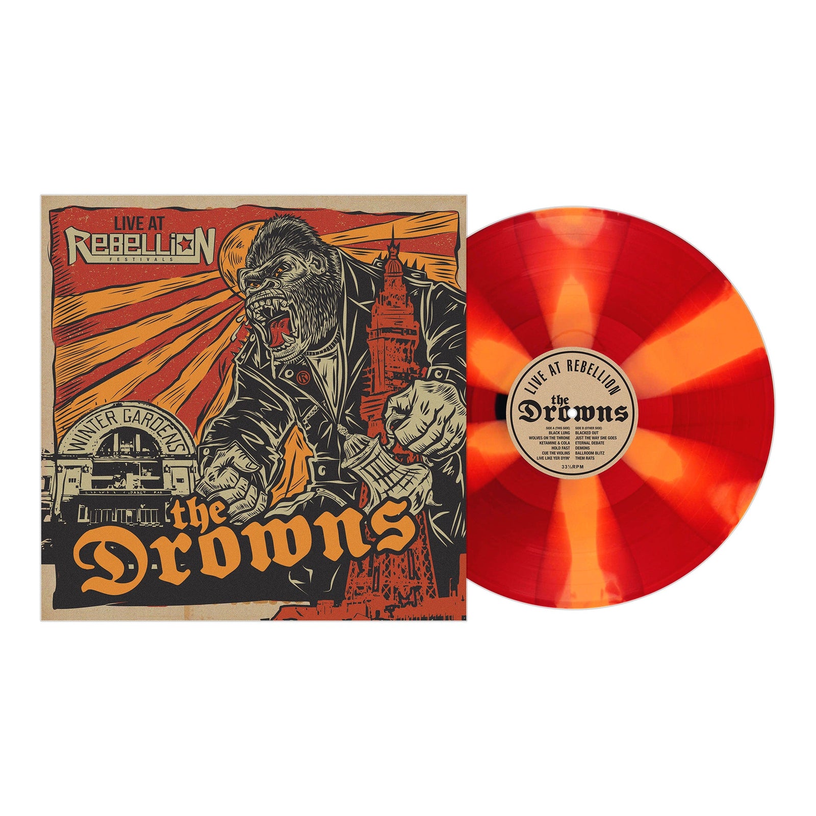 A red and orange marbled vinyl from The Drowns sits beside its cover, which shows a roaring gorilla in a suit destroying buildings, with The Drowns and Live at Rebellion prominently displayed.