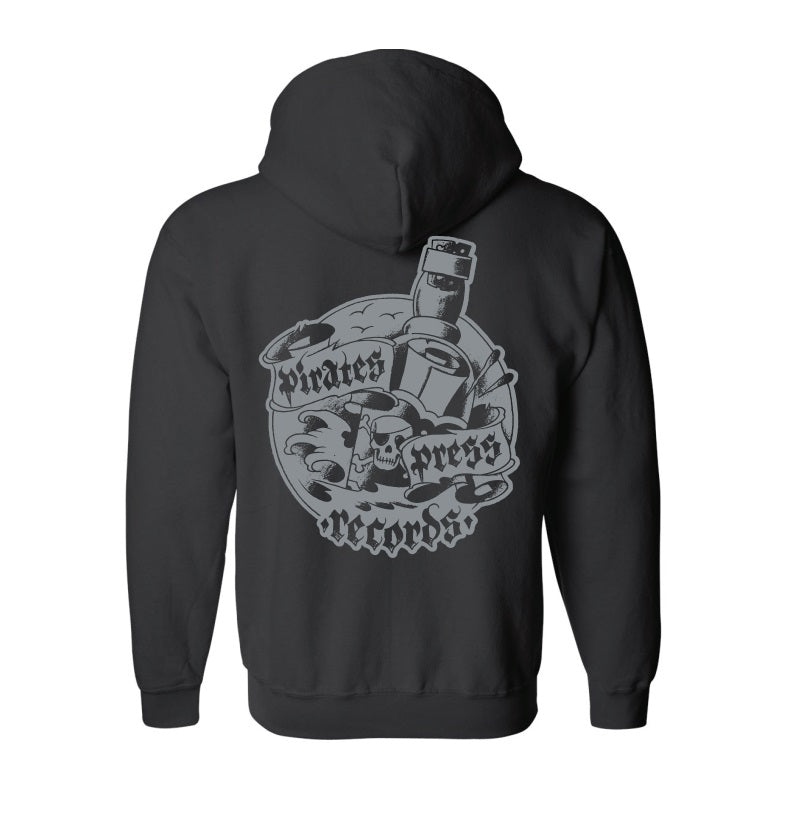 A black zip-up hoodie from Pirates Press Records featuring a large back graphic with a skull, crossed bottles, and bold, stylized branding.
