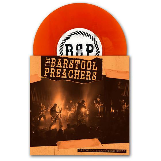 An orange vinyl record partly slides from its sleeve, which features The Bar Stool Preachers performing on stage with Grazie Governo in bold above them. The record label displays the initials BSP.