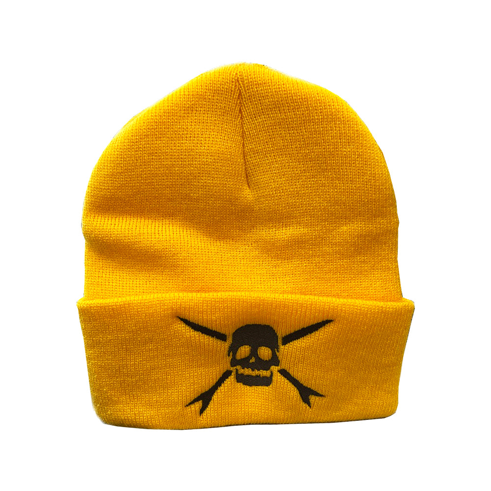 A gold beanie by Teenage Bottlerocket featuring a black skull and crossbones logo on the front fold, inspired by their edgy style.