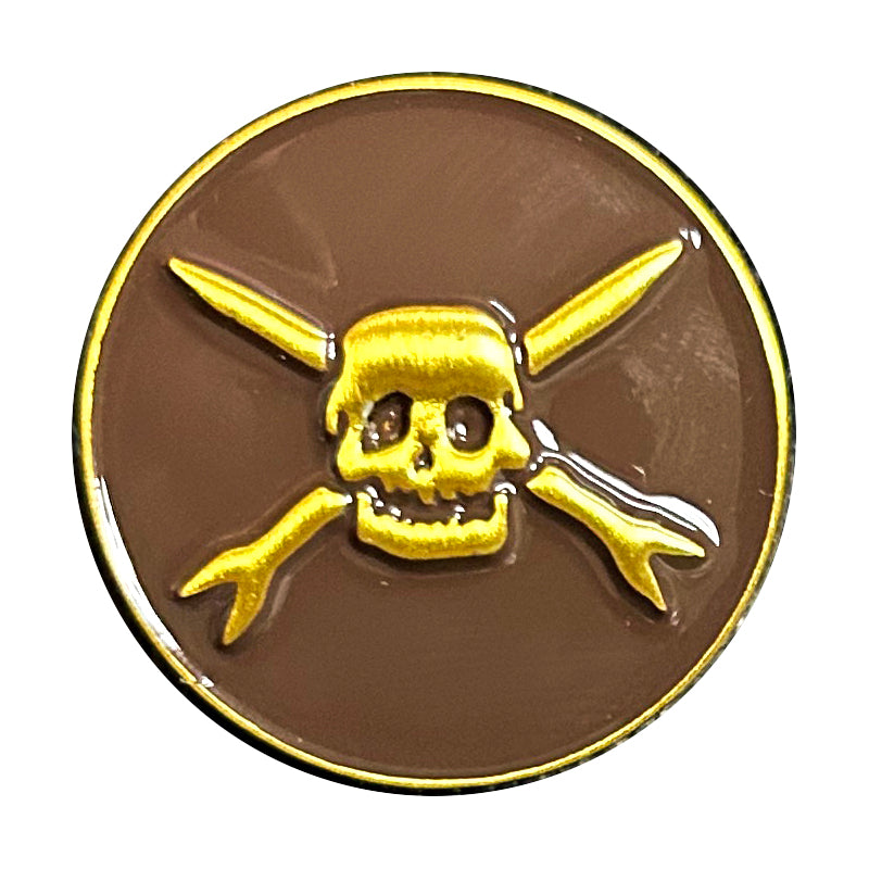 A round enamel pin featuring a yellow skull and crossbones on a brown &amp; gold background with a gold border—an ideal accessory for Teenage Bottlerocket fans.