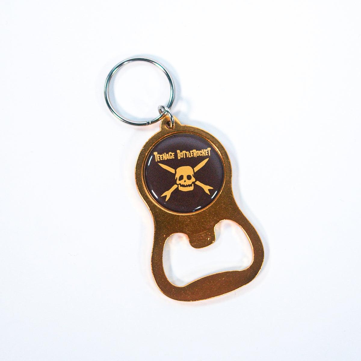 A metal keychain bottle opener from Teenage Bottlerocket featuring a circular skull and crossbones emblem with the band name on a bold black background.