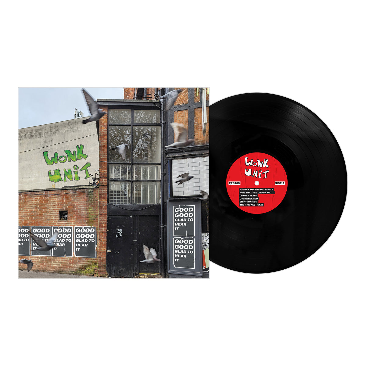 A vinyl record and cover by Wonk Unit, featuring a brick building with Wonk Unit graffiti, flying pigeons, and windows displaying GOOD GOOD BAD HEAD TO HEAD. The record label is red and white.