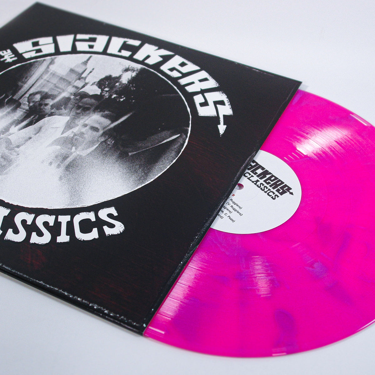 A vibrant Ultra Violet Marble Vinyl LP slides out from a black album cover labeled “The Slackers Classics,” showcasing a black-and-white band photo in a circular frame—a must-have collectible for fans of The Slackers.