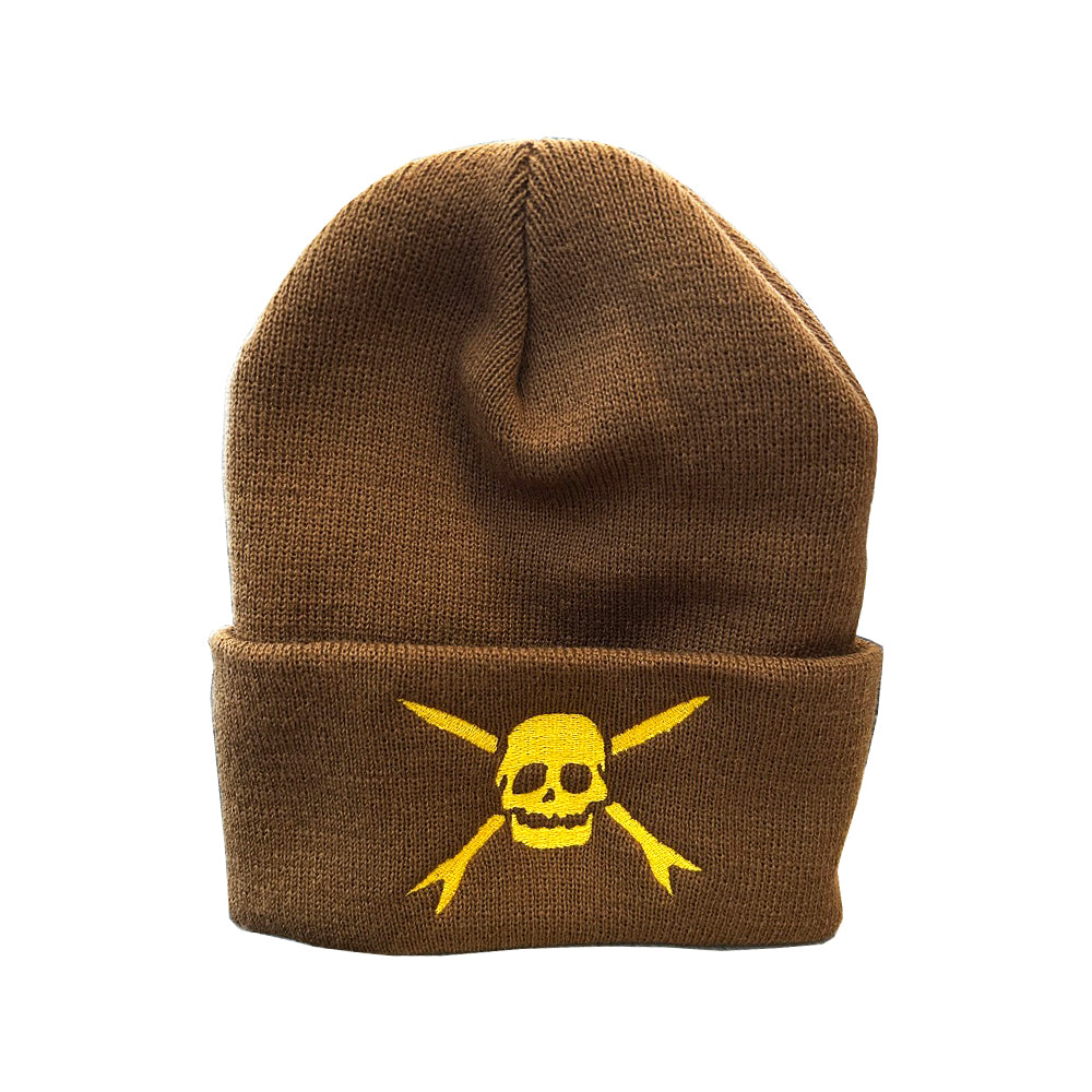 A brown beanie from Teenage Bottlerocket featuring a yellow skull and crossed bones graphic on the folded brim, inspired by the band’s iconic style.