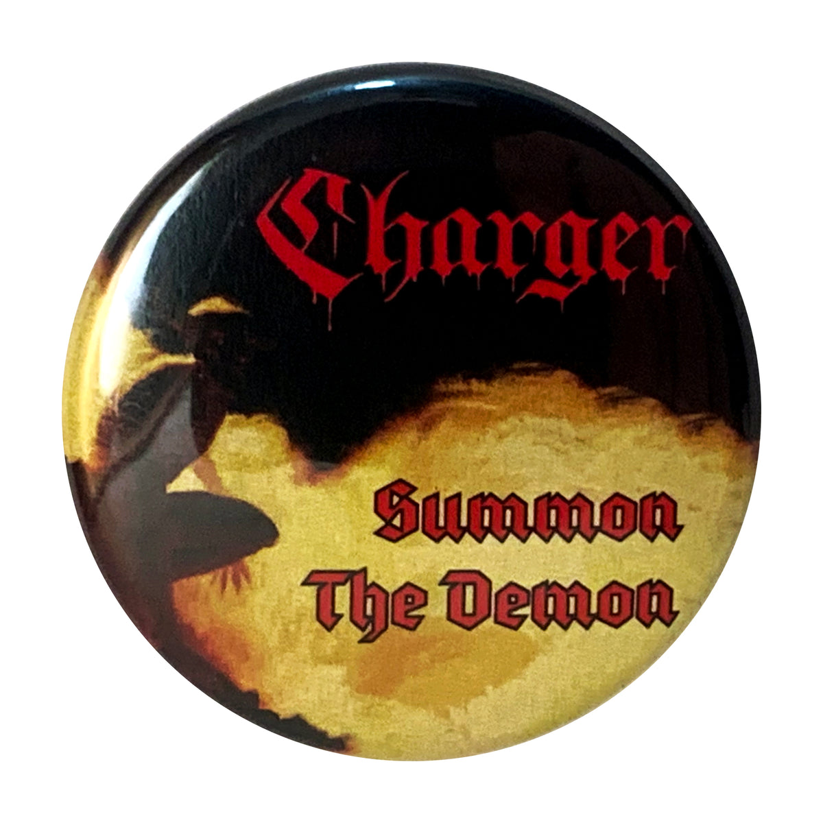A round band button featuring a shadowy figure before yellow flames, with Charger at the top in red gothic font and Summon The Demon below in matching style.