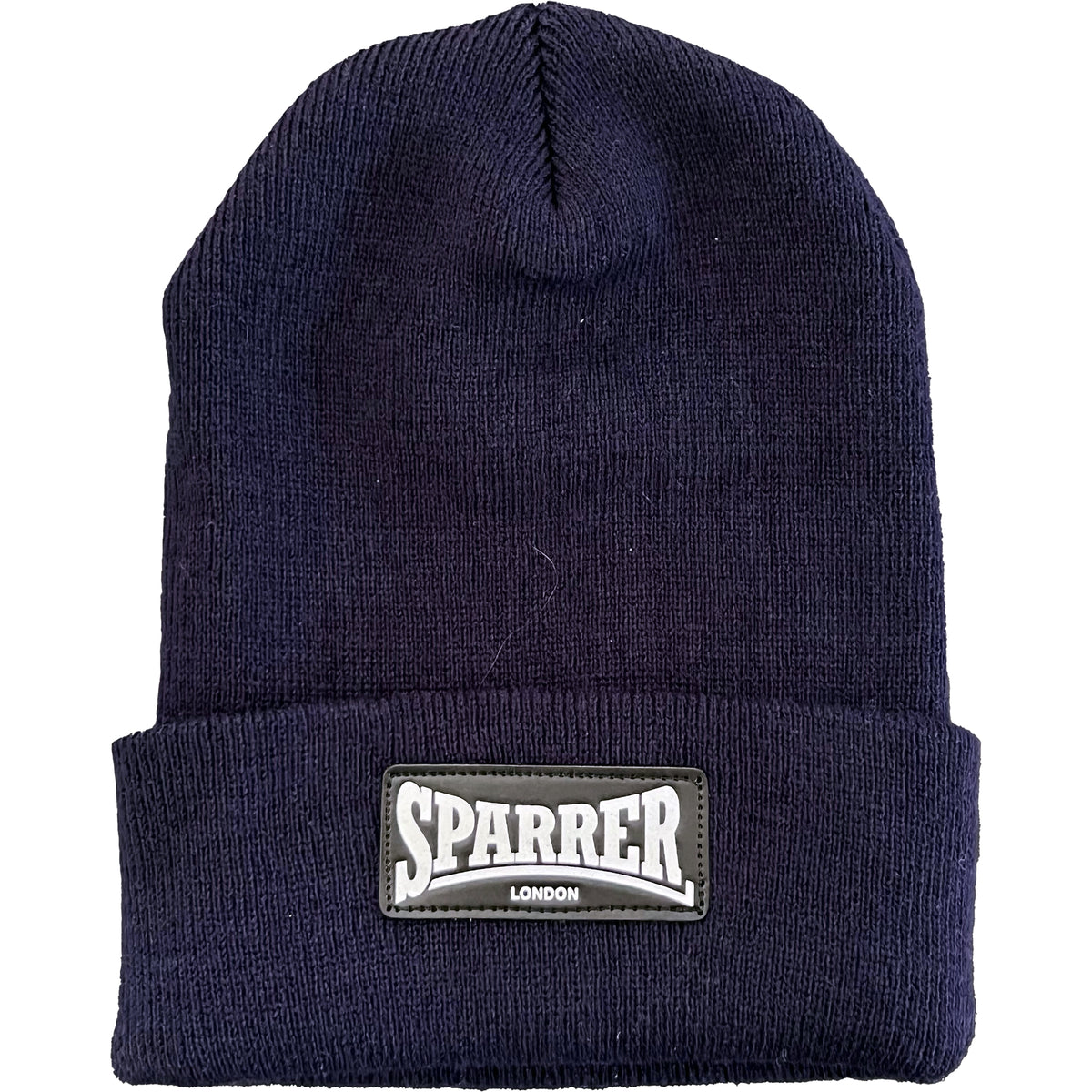 A navy blue Cock Sparrer beanie with a folded brim, featuring a rectangular London patch that reads SPARRER LONDON in white letters.