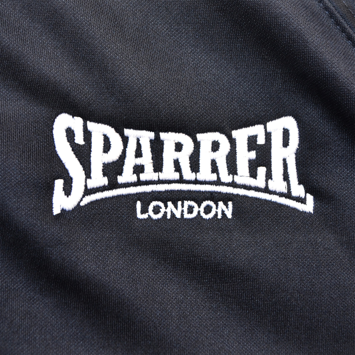 Black fabric with white embroidered SPARRER in large letters and LONDON beneath, inspired by the iconic Cock Sparrer track jacket from independent brand Cock Sparrer.