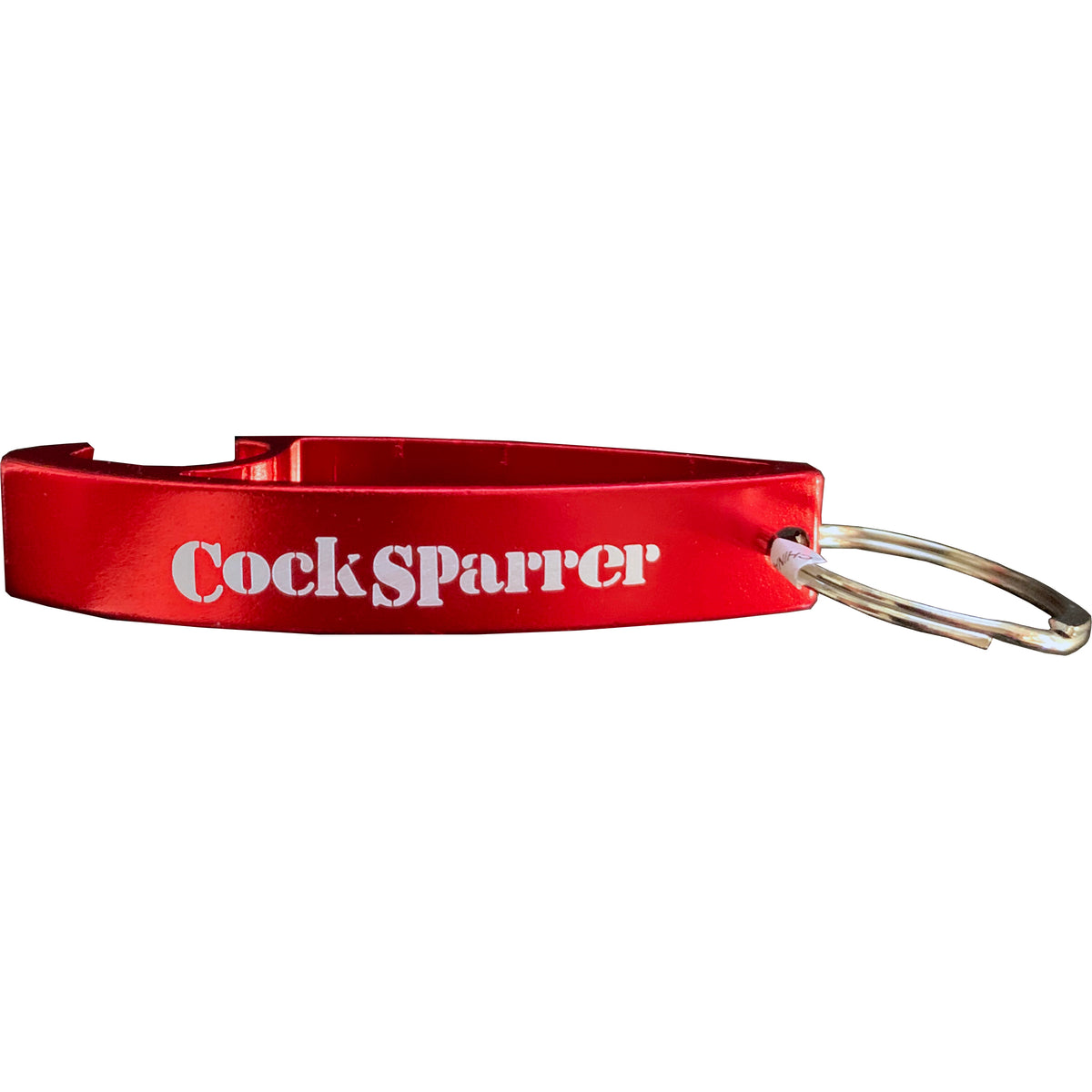 A red metal Cock Sparrer keychain bottle opener with the Cock Sparrer logo printed in white on the side.