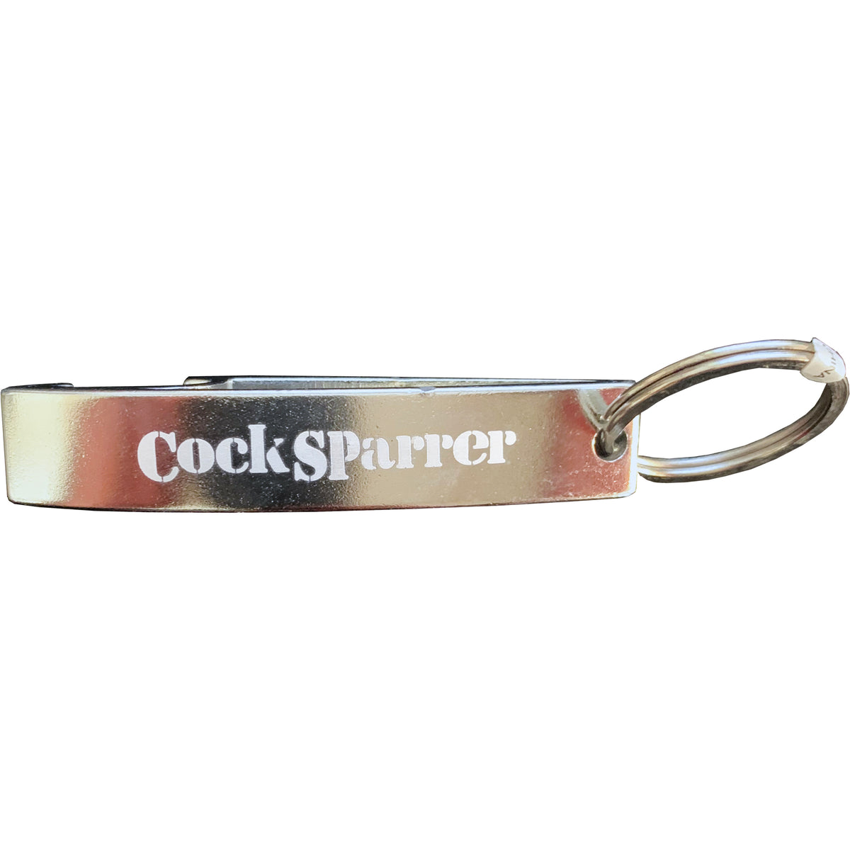A metallic keychain bottle opener featuring the Cock Sparrer brand name engraved on the side in white text.