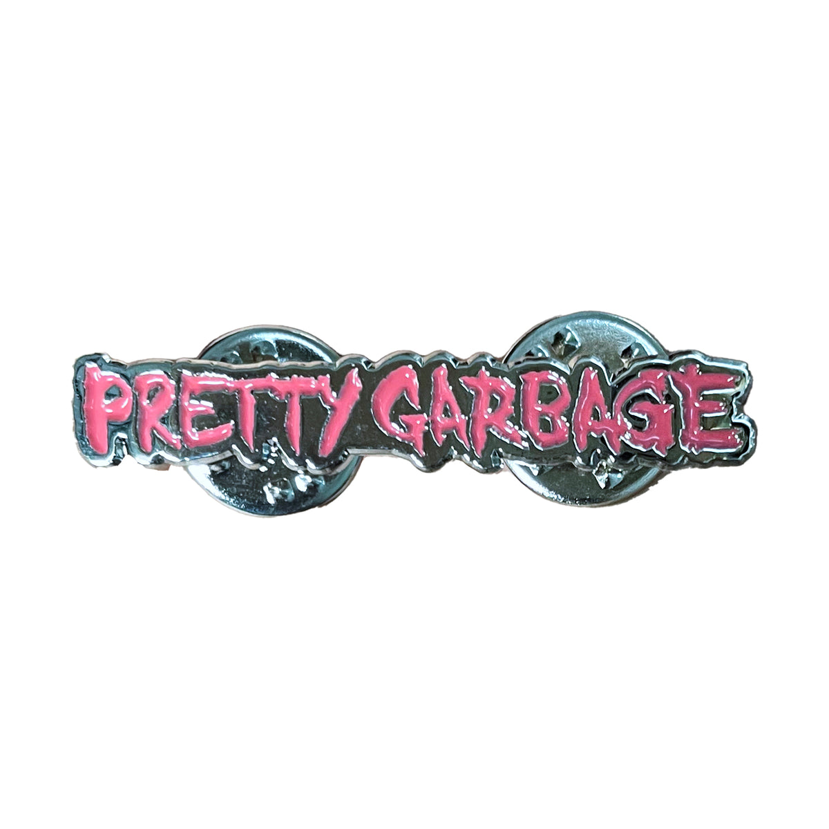 A metallic enamel pin by Come Closer featuring bold, pink, graffiti-style &quot;Pretty Garbage&quot; lettering on a silver background, with two pin clasps on the back.