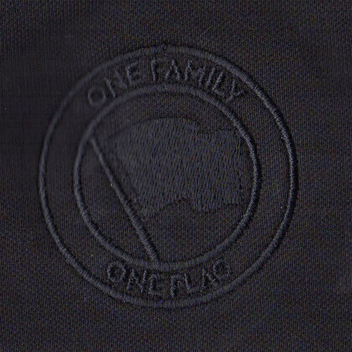 A black fabric patch from Pirates Press Records features an embossed circular emblem with a flag and “ONE FAMILY” above and “ONE FLAG” below, all in black-on-black stitching—ideal for your One Family One Flag polo or gear.