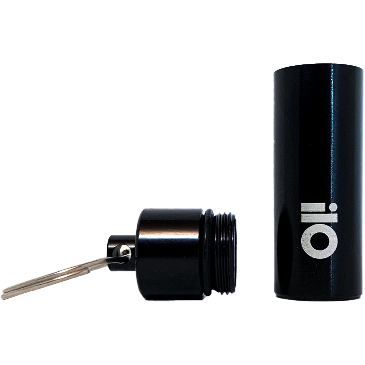 A black cylindrical pill case with a screw-off lid, attached to a keyring, branded with &quot;Pirates Press Records&quot; in white on the side. Sleek and practical as an ear plug case, it sits beside its open container.