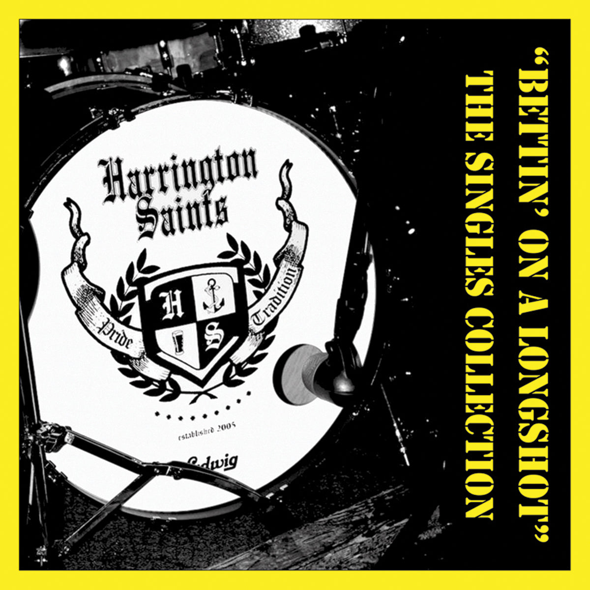 A drum with the Harrington Saints logo and “Pride” and “Tradition” text sits by a yellow border featuring “Bettin’ On A Longshot: The Singles Collection,” a bold punk singles release title in striking black letters.