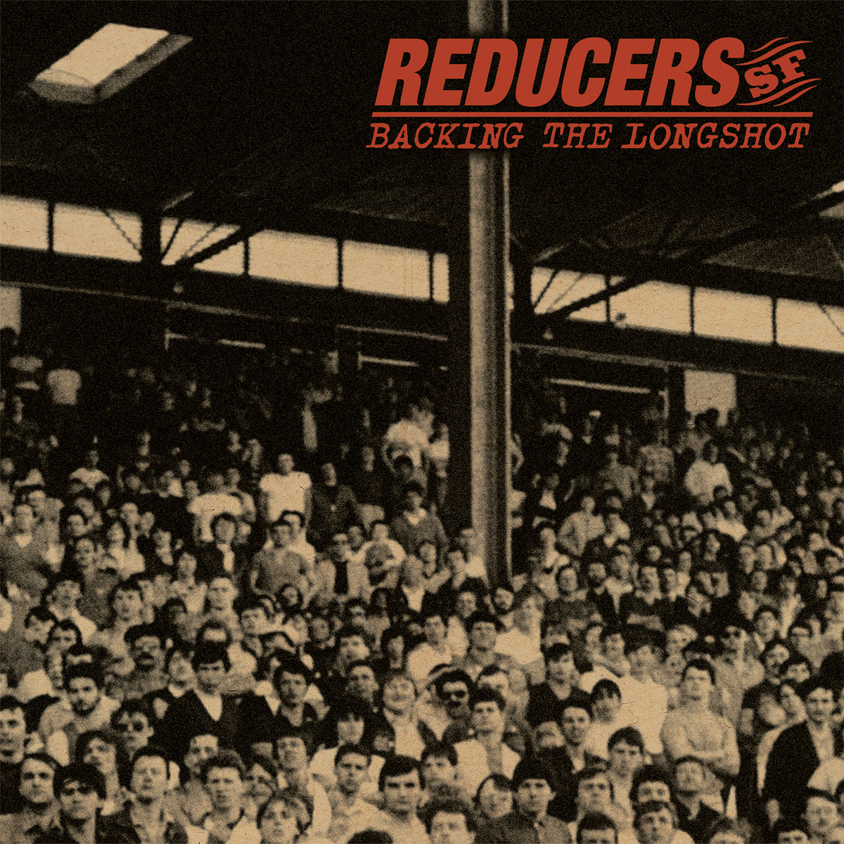 Sepia-toned photo of a stadium crowd under a roof, with “Reducers S.F Backing the Longshot” in bold red at top right—a classic street punk vibe from Reducers S.F, ideal for colored vinyl collectors.