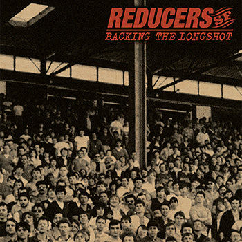 A sepia-toned photo of a packed stadium captures Bay Area street punk spirit, as people face the camera. Reducers S.F and BACKING THE LONGSHOT appear in red at the top right, highlighting the Reducers S.F brand.