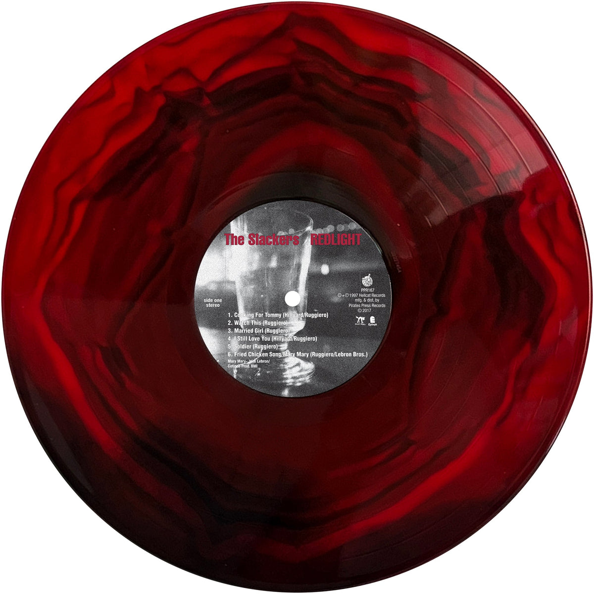 A marbled red and black Redlight vinyl record by The Slackers features a central label that reads The Stalker’s Delight, with white and red track listings reminiscent of a classic ska album.
