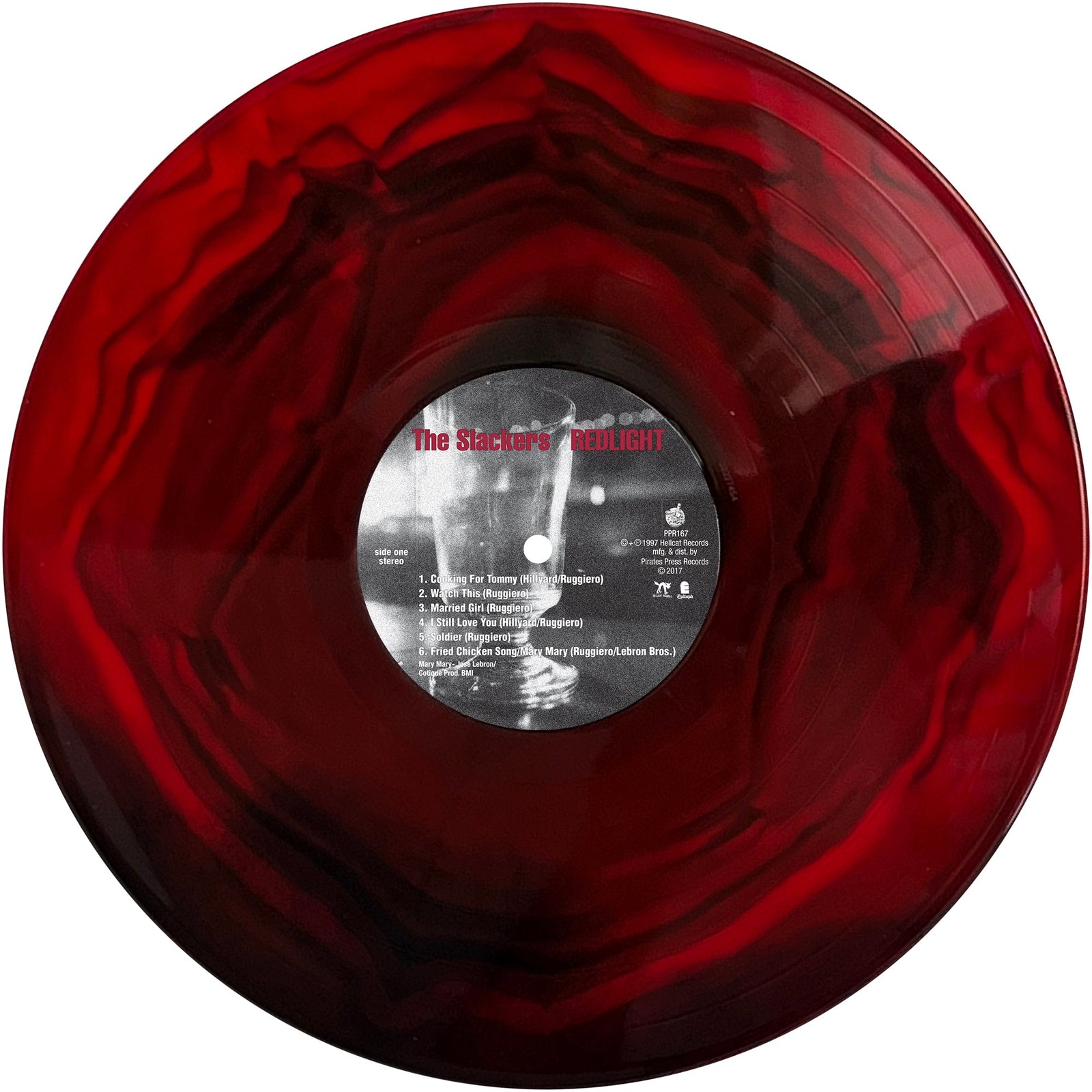 A marbled red and black Redlight vinyl record by The Slackers features a central label that reads The Stalker’s Delight, with white and red track listings reminiscent of a classic ska album.