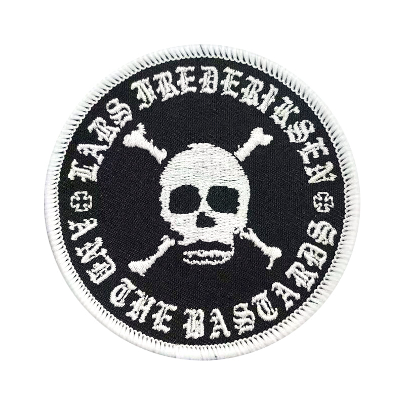 A round embroidered patch with a white skull and crossbones on a black background. Surrounding the skull are the words Lars Frederiksen and The Bastards in white text, inspired by their self-titled debut album.