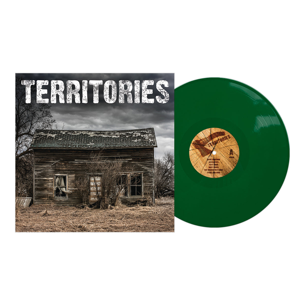 A green vinyl record from the Territories album rests beside its cover, which shows a weathered wooden house beneath a cloudy sky. The brand name, Territories, appears in bold white letters at the top.
