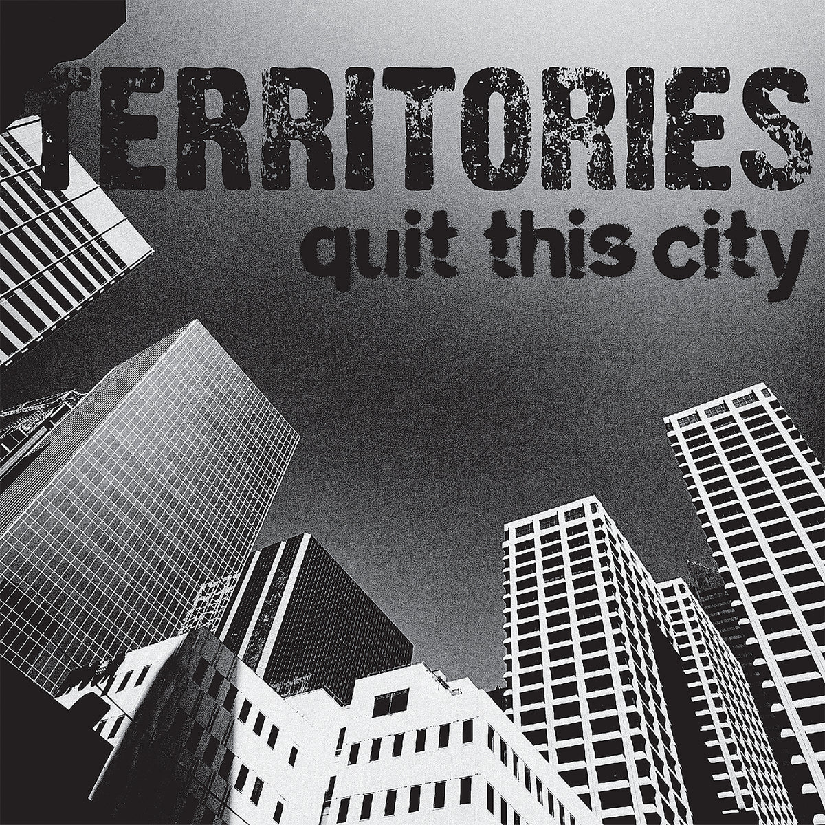 Black and white image of tall skyscrapers viewed from below with TERRITORIES quit this city in bold, distressed letters—a striking nod to Territories’ 7 Milky Clear Vinyl release, When The Day Is Done.