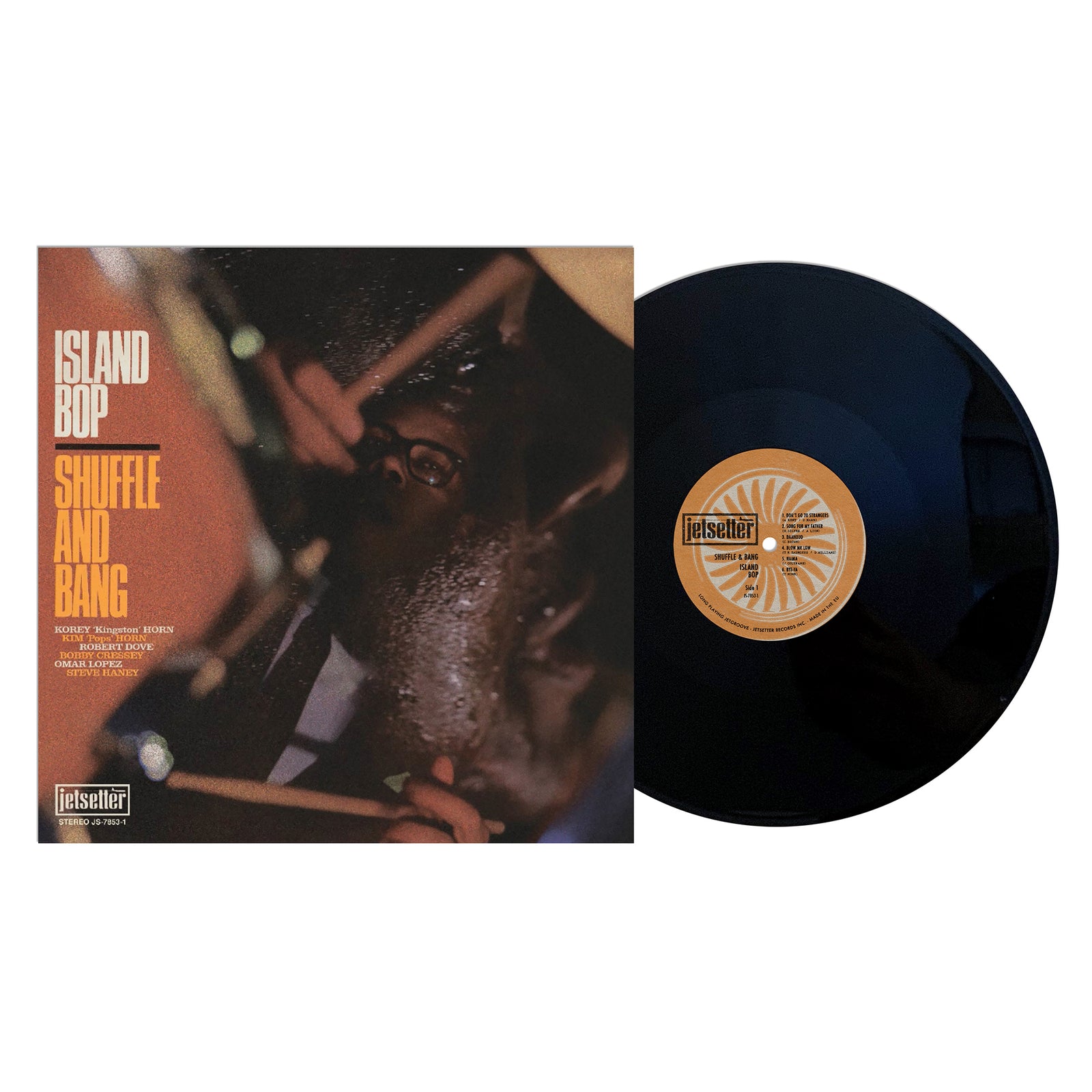 A vinyl record partly out of its cover. The cover features a jazz drummer and text: Shuffle and Bang—an album blending jazz, dub, and reggae—with album, brand name (Shuffle and Bang), label details on a dark background.