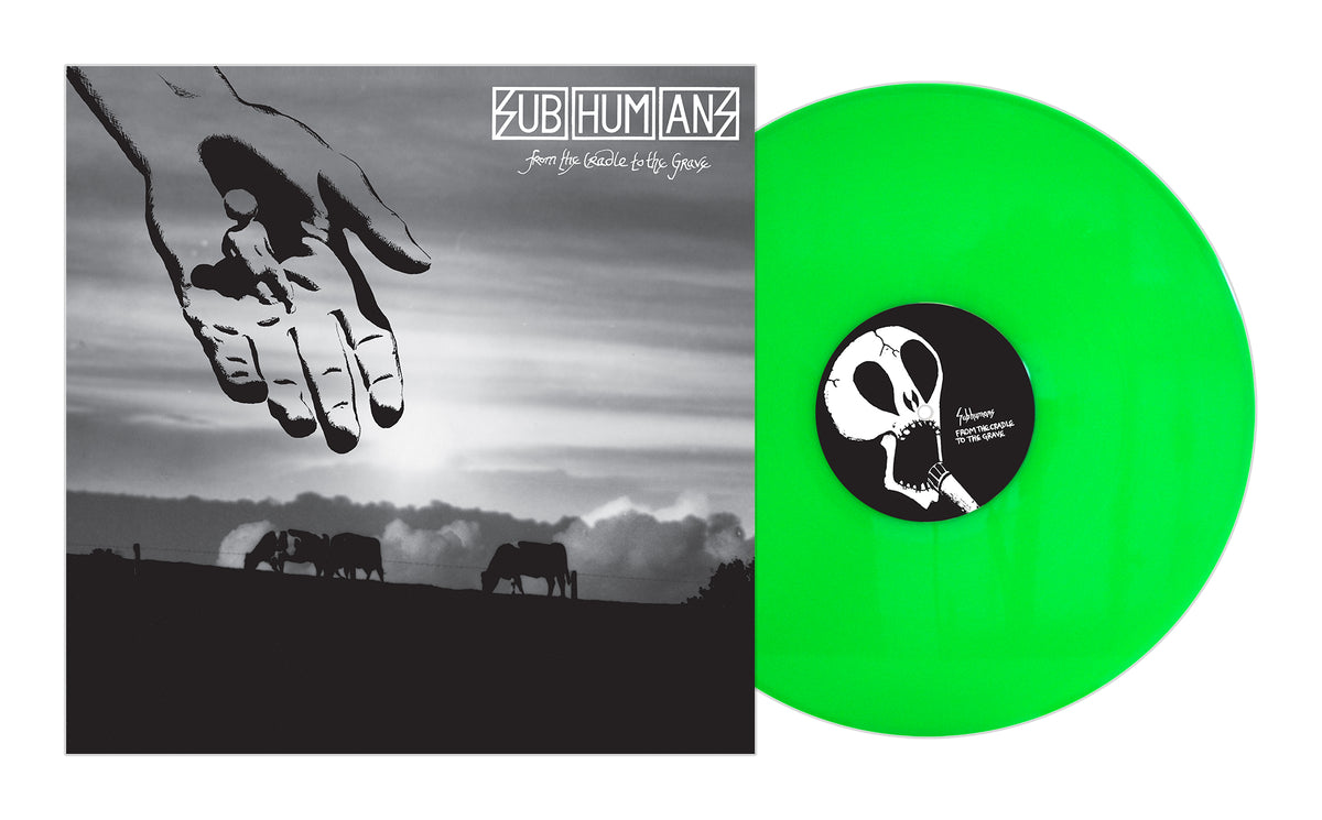 The Subhumans From the Cradle to the Grave album cover displays black-and-white anarcho punk art: a hand holding a small figure over grazing animals, paired with a vivid green vinyl record. Brand Name: Subhumans.