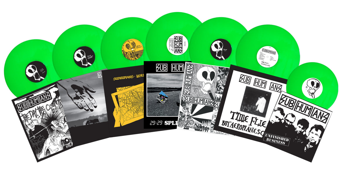 Seven bright green vinyl records with black-and-white anarcho punk album covers—mainly labeled Subhumans or from the Unfinished Business box set—are displayed against a white background.