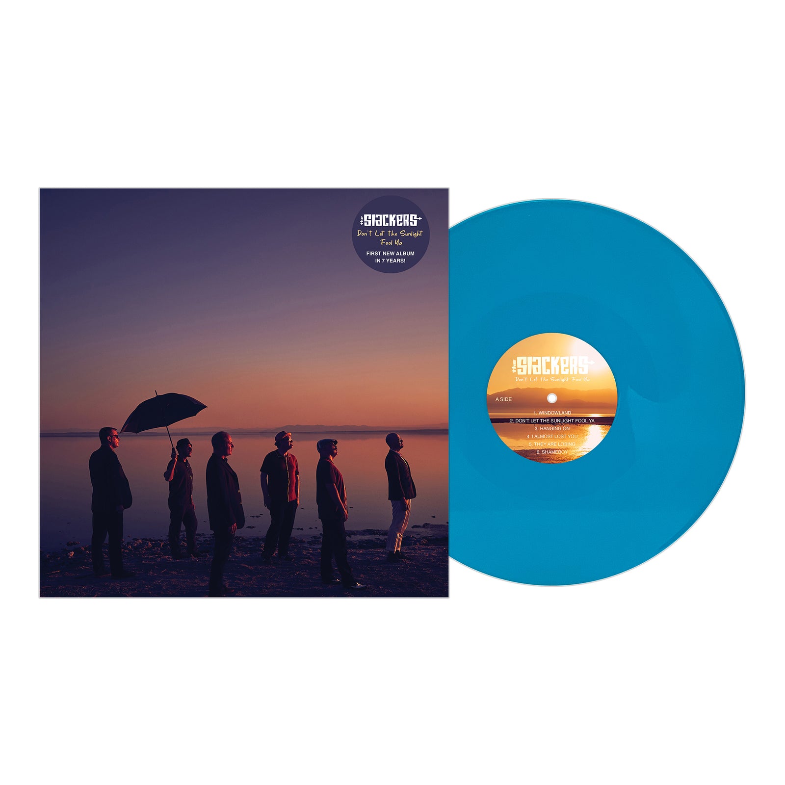A blue vinyl record by The Slackers is partially out of its album cover, which shows six people by a shoreline at sunset with The Slackers name and the Pirates Press Records logo on an orange and purple background.