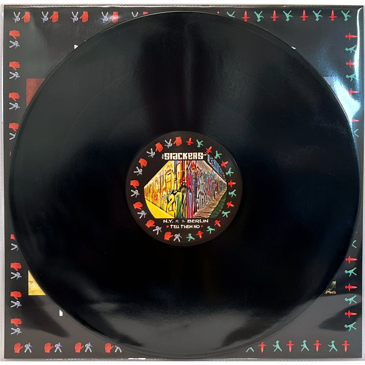 A black UV digitally printed vinyl by The Slackers features a graffiti-style label and sleeve with colorful human silhouettes, displaying the band’s name, NYC reggae vibes, city names, and vibrant street art.