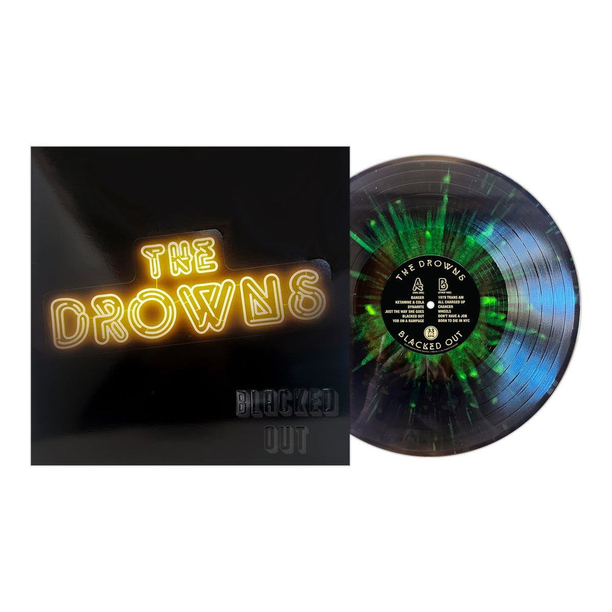 Vinyl record with green and black splatter design displayed beside its album cover, featuring The Drowns Blacked Out in neon-style, raised lettering—a striking release from The Drowns.