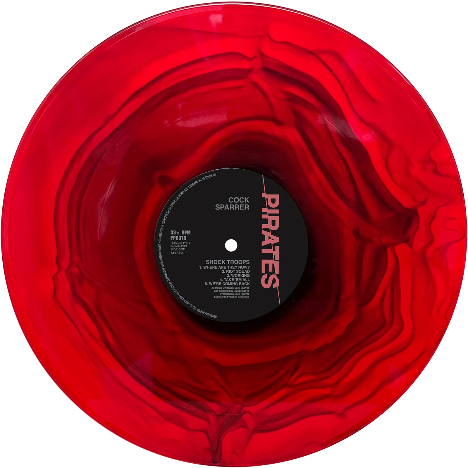 A red and black marbled vinyl record with a swirling pattern celebrates Cock Sparrer’s classic Oi! punk album Shock Troops, featuring the band’s name and bold “Pirates” text on the label.