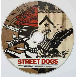 The Street Dogs EP features bold half-split artwork: a red and black helmet with drumsticks on one side, and a patriotic eagle holding arrows and an olive branch on the other. Available on Gold or Tricolor Vinyl.