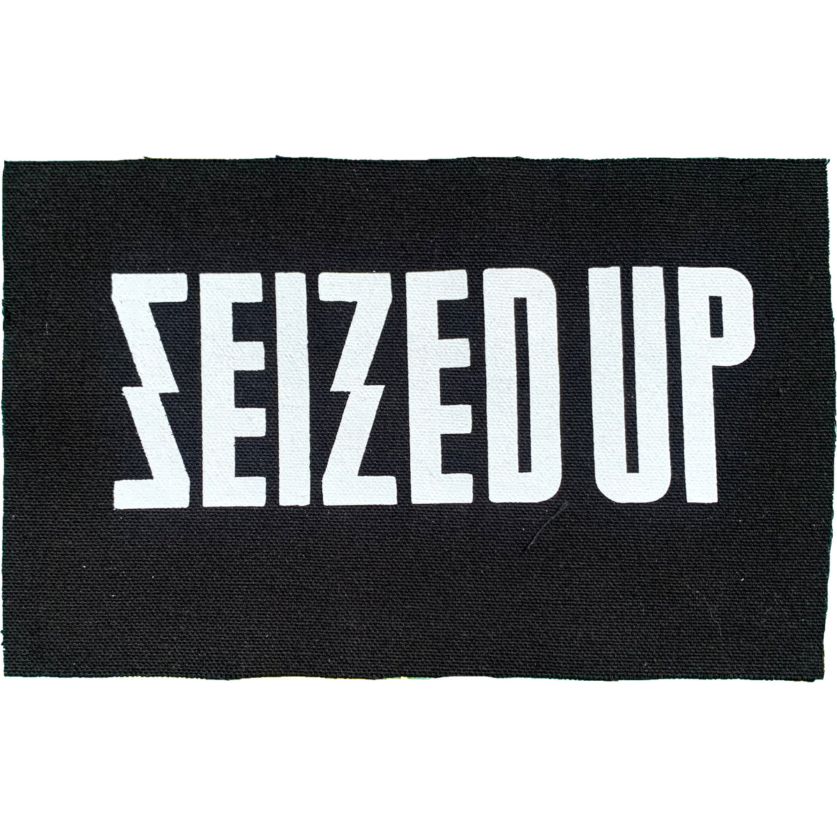 Black cloth patch from Seized Up featuring bold, all-caps white text “SEIZED UP” with a stylized lightning bolt S—a striking logo accessory.