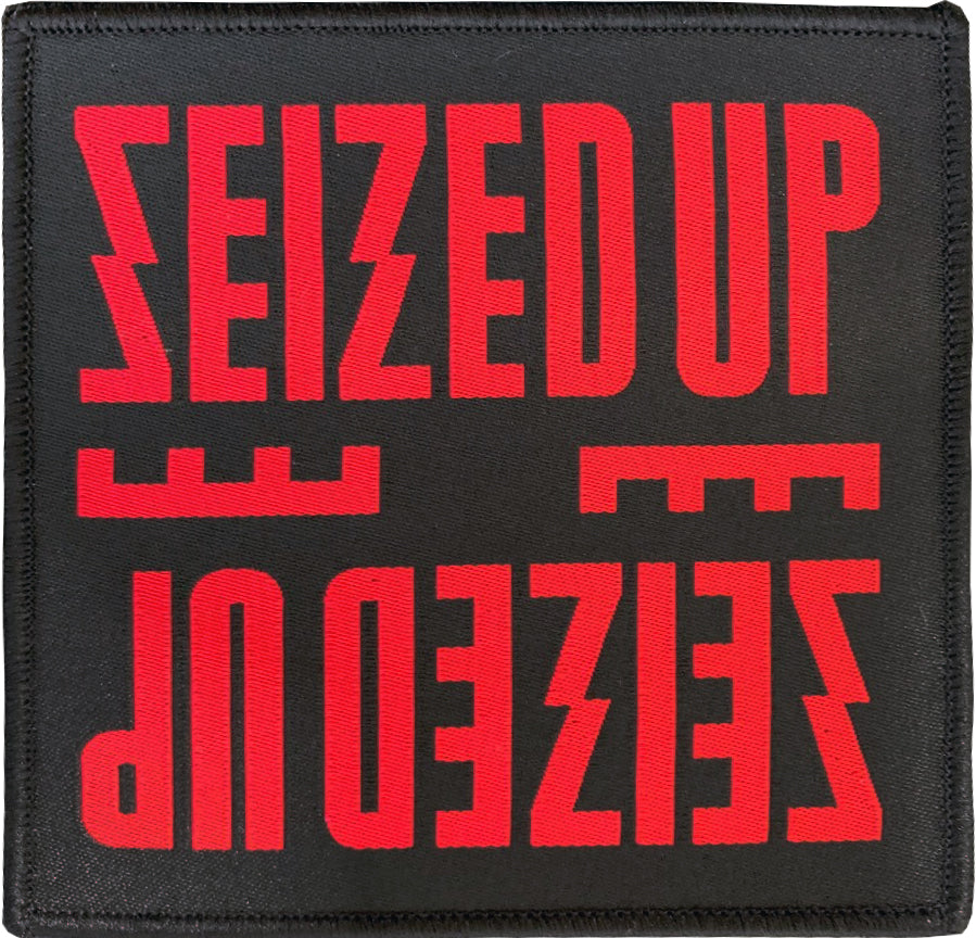 Seized Up patch with bold red uppercase &quot;SEIZED UP&quot; in a stylized block band logo font appears at the top and upside down at the bottom on a black background. Woven design by Seized Up.