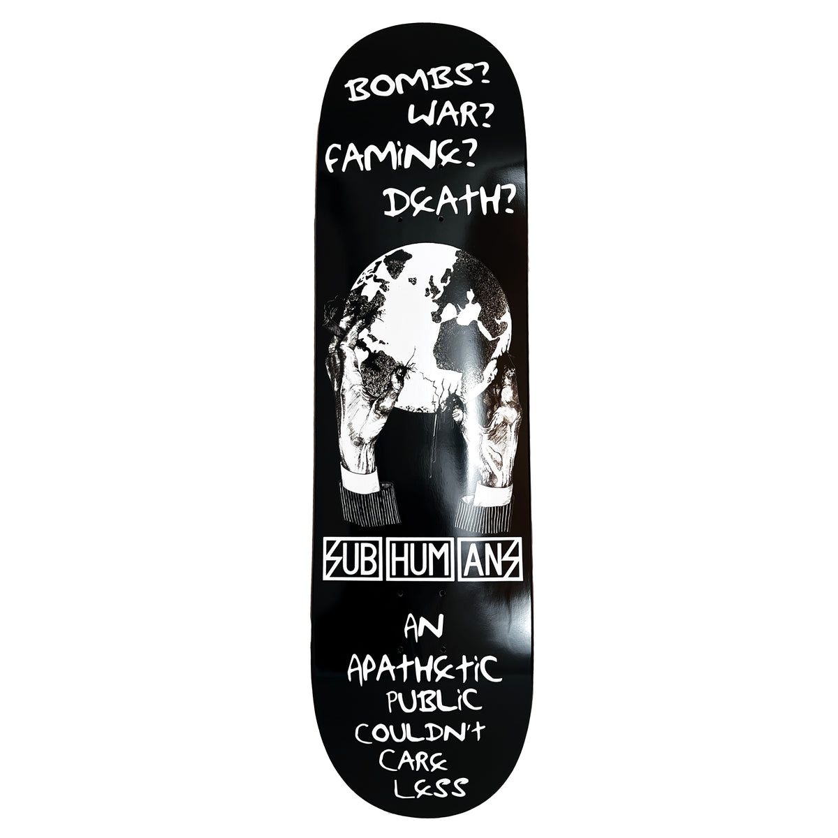 The Subhumans maple skateboard deck showcases their Hands/World design: black-and-white gloved hands holding a globe with text—Bombs? War? Famine? Death? Subhumans. Highlights societys apathetic response.