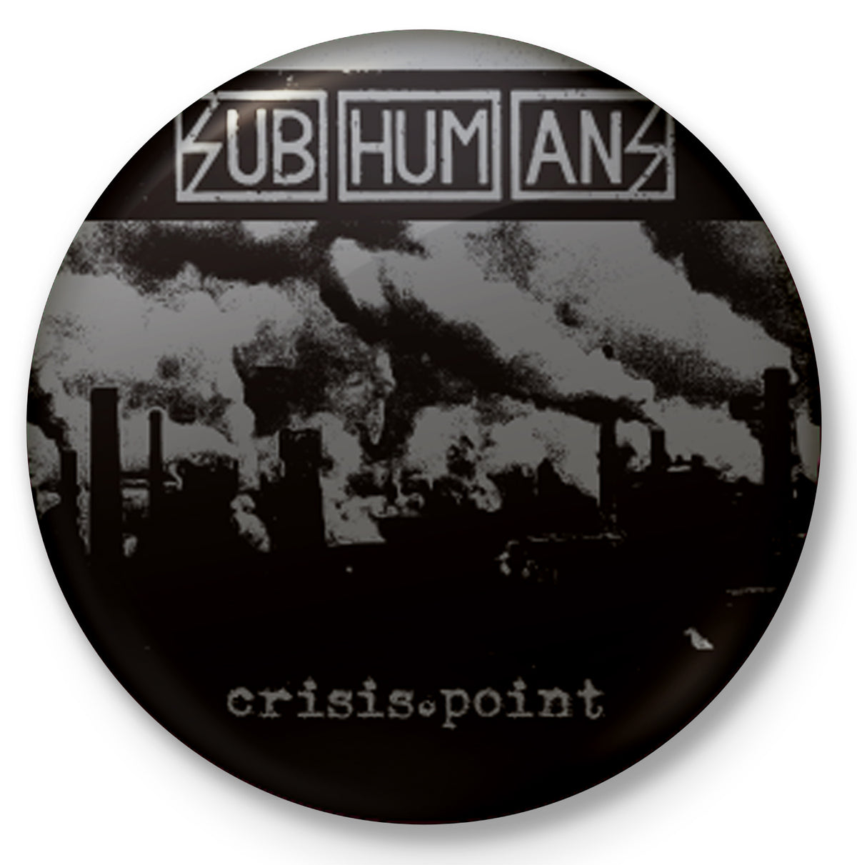 A round button features the Subhumans name in a boxy font above an industrial scene with smokestacks releasing dark smoke. &quot;Crisis Point&quot; is displayed at the bottom in a typewriter-style font.