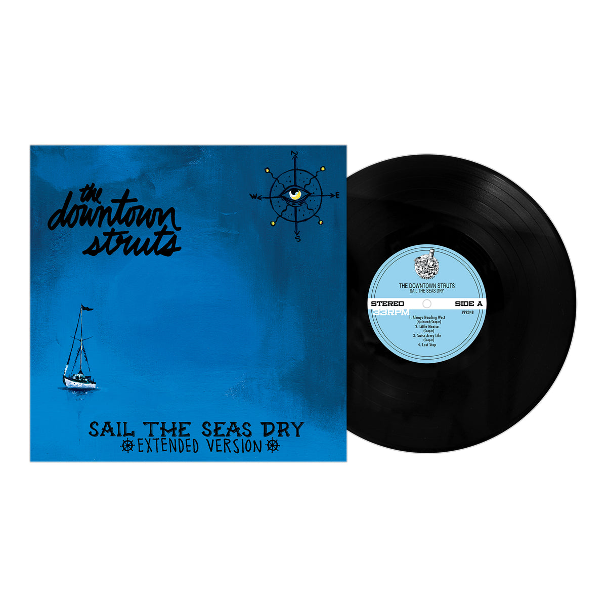 A black vinyl record is partially pulled from a blue cover featuring a sailboat, a compass with an eye, and text: Downtown Struts – Sail The Seas Dry (Extended Version), released by Pirates Press Records. Brand: Downtown Struts.