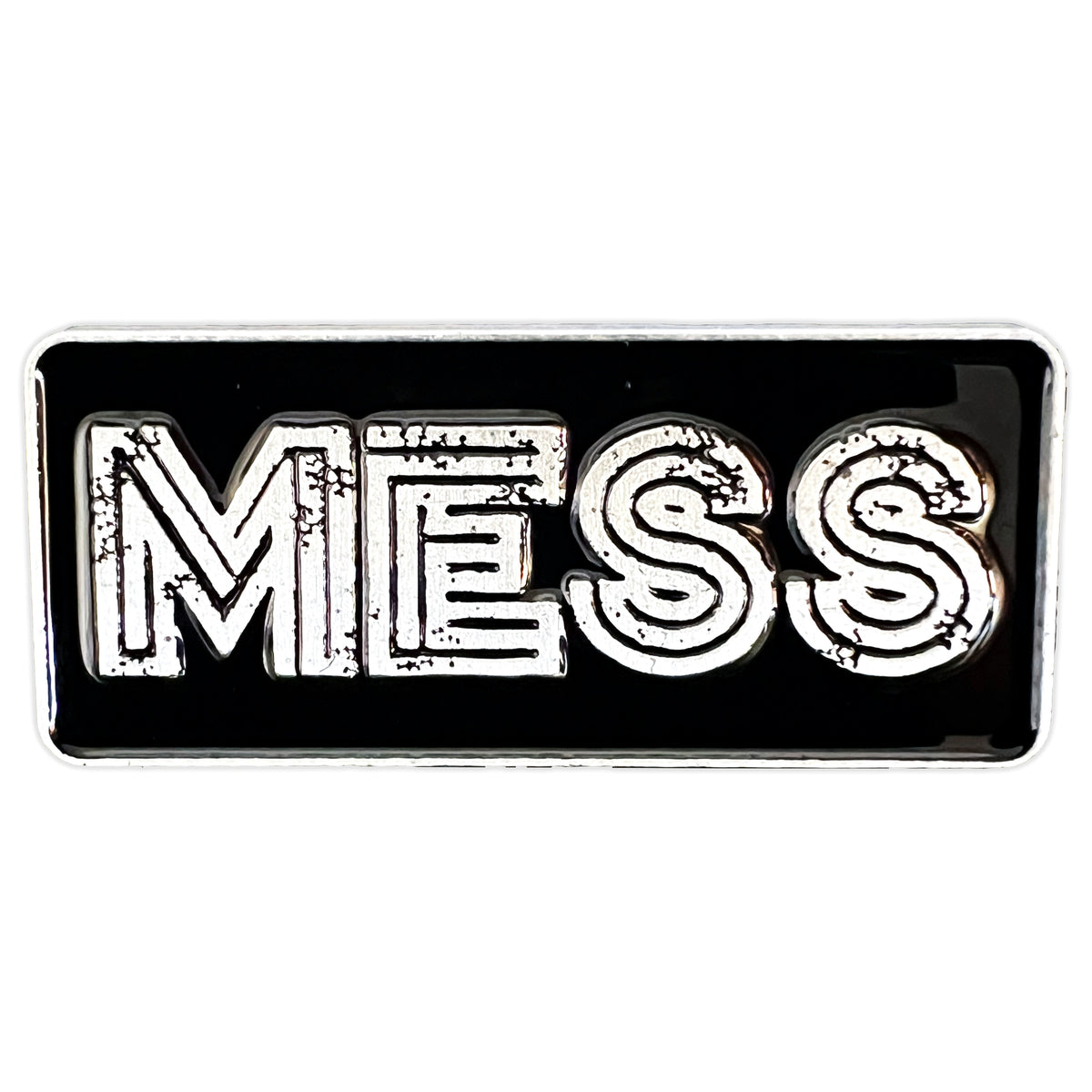 A rectangular black enamel pin by Mess, featuring the word MESS in bold, outlined, distressed white capitals—a striking addition to any pin collection.