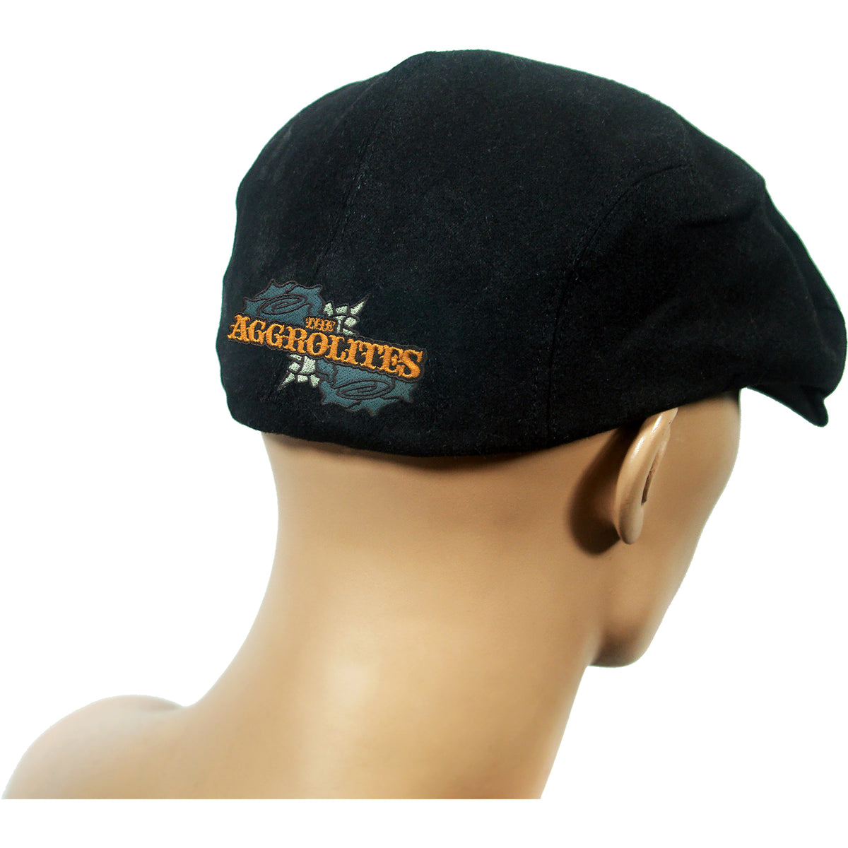 A mannequin head displays a black scally cap from The Aggrolites, featuring their logo embroidered in orange and gray text on the back.