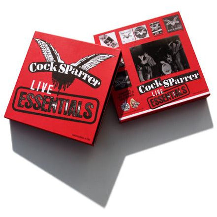 Two red CD cases for Cock Sparrer showcase the band’s name and winged logo with punk-inspired graphics and live band photos, all casting shadows on a white background.