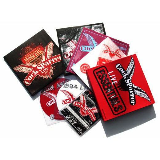 Cock Sparrer CD albums and cases, featuring Live Essentials and live performance recordings, are arranged fan-style on a white background. Some CDs are partially out of their cases, highlighting the Cock Sparrer brand logo and cover art.